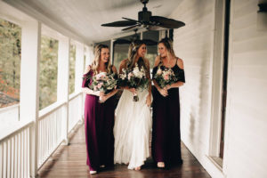 Bridal party laughing on the porch of The Wheeler House